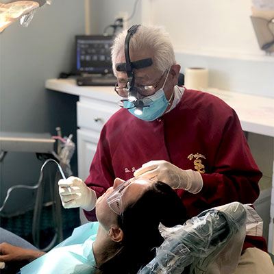Joseph Abe, DDS working on a patient