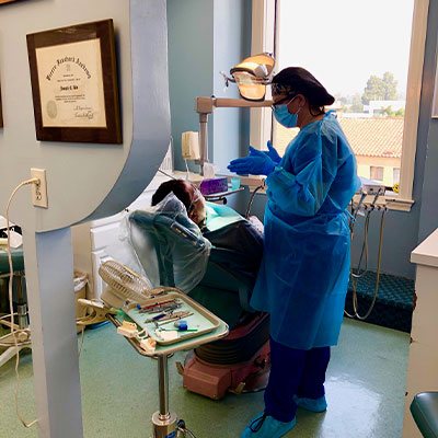 Joseph Abe, DDS dental assistant with a patient